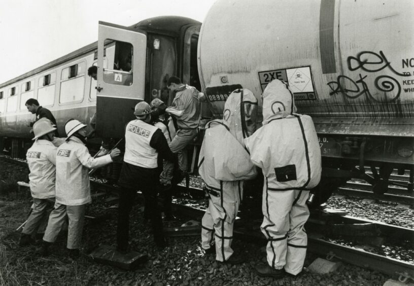 Image shows members of the emergency service helping people get off the train. Image: DC Thomson.