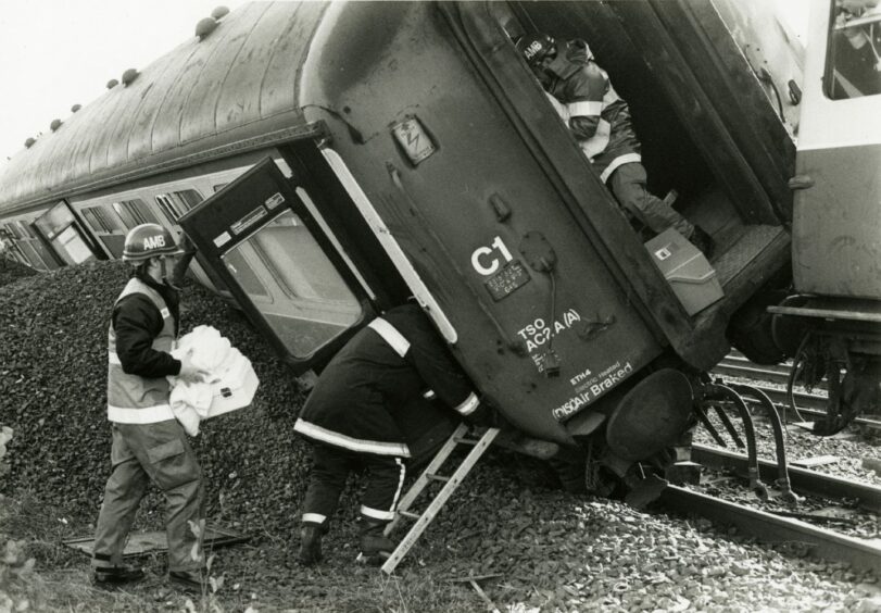 Emergency services workers enter a derailed carriage as part of Blue Iris