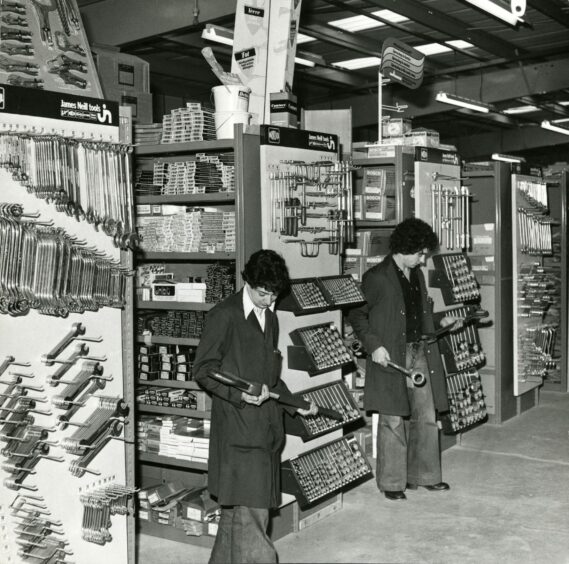 Two men holding tools in White, Milne &amp; Co, Baird Avenue, Dundee. Image: DC Thomson.