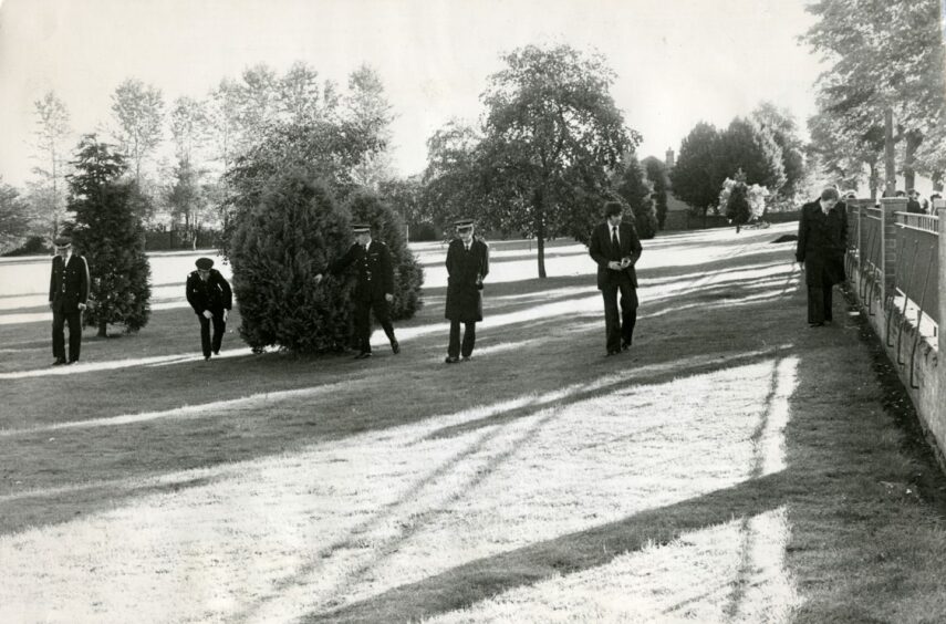 Police searching for clues following the fire. Image: DC Thomson.