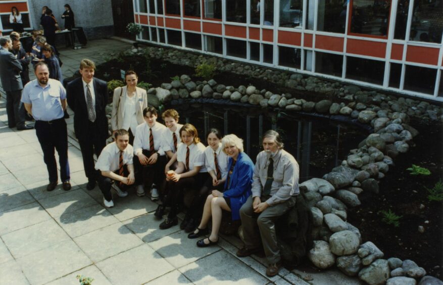 Pupils and staff beside the garden pond. Image: DC Thomson.
