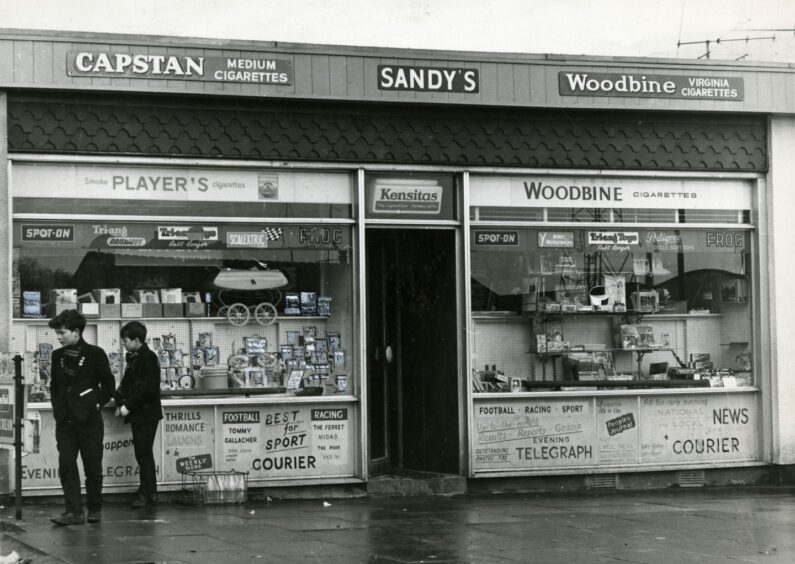 Two boys outside Sandy's Store. Image: DC Thomson.