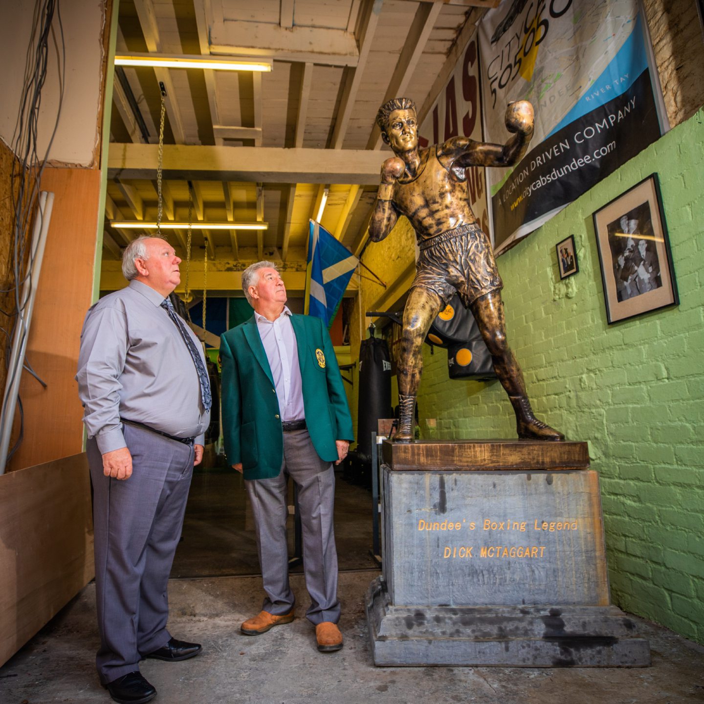 Club president Jimmy Marr and club secretary Norrie McVicar look up at the Dick McTaggart statue. Image: Steve MacDougall/DC Thomson.