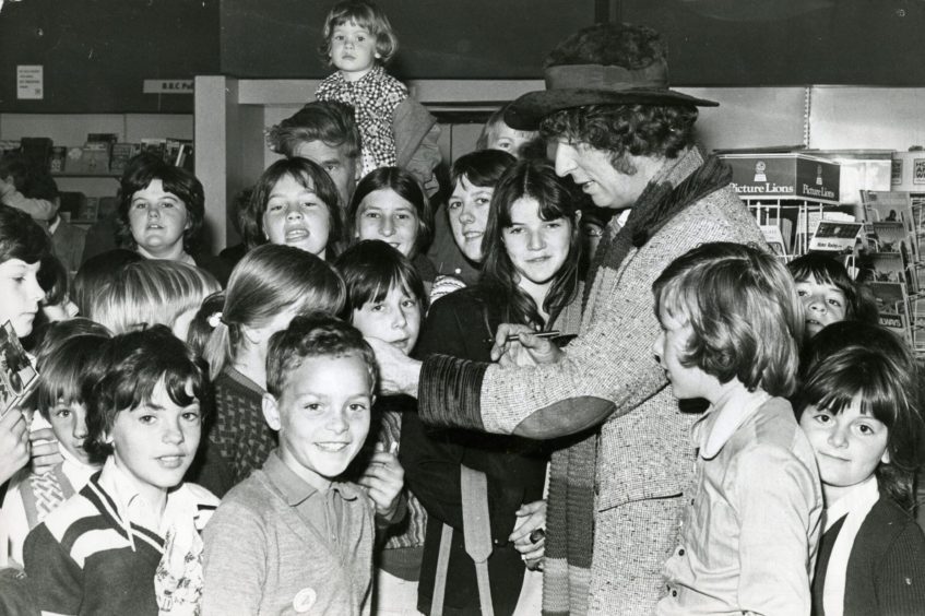 Fans crowd around as Tom Baker visits John Menzies in the Murraygate in September 1976. Image: DC Thomson.