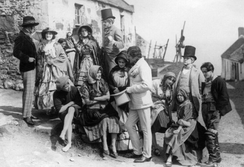 Actors in costume gather in the village during filming of Christie Johnstone, a romance directed by Norman McDonald and filmed in Auchmithie. Image: Supplied.