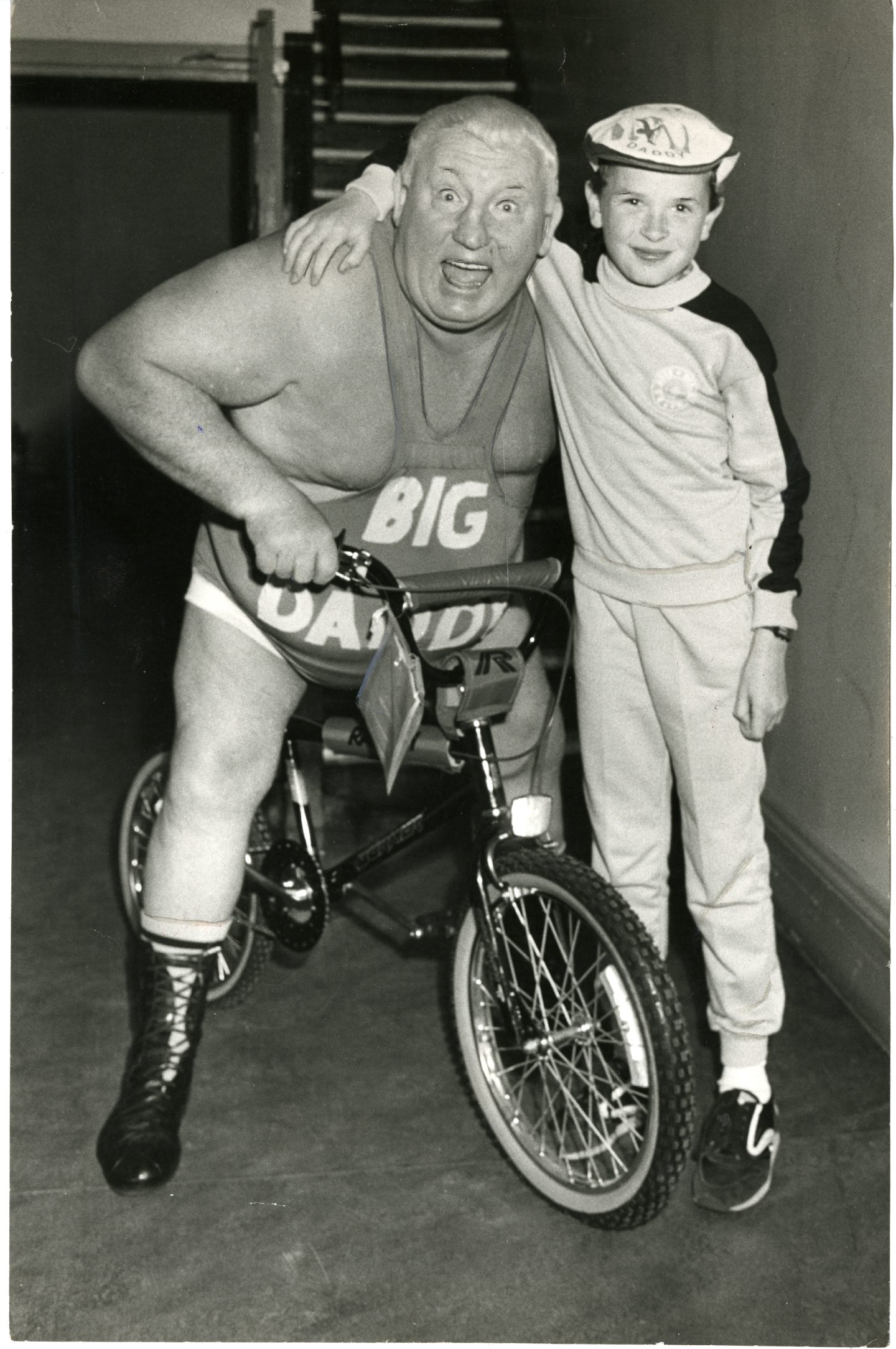 Big Daddy gets on his bike at the Caird Hall alongside a fan in 1985. Image: DC Thomson.
