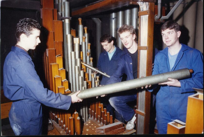 A team dismantling the Caird Hall organ and taking parts away for repair.