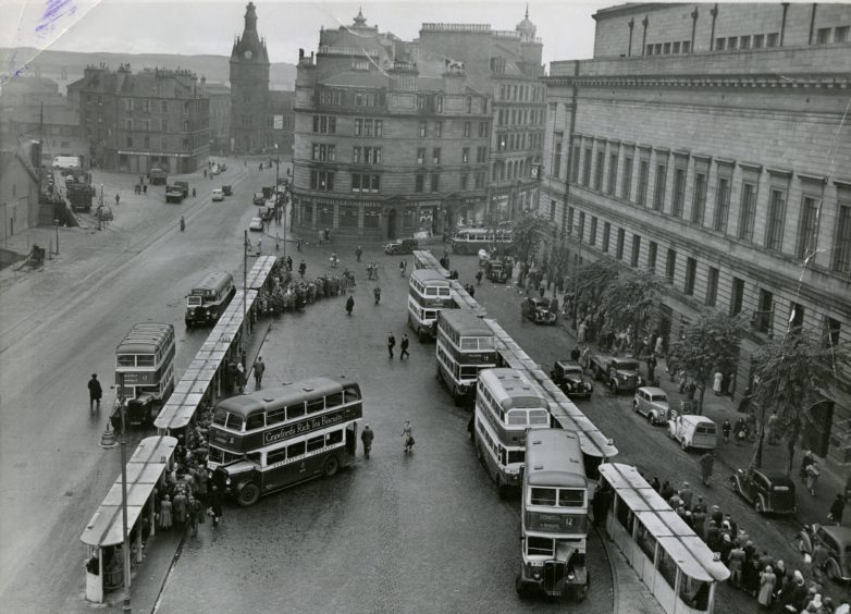 A view of the bus station and passenger stances behind the Caird Hall in 1952.