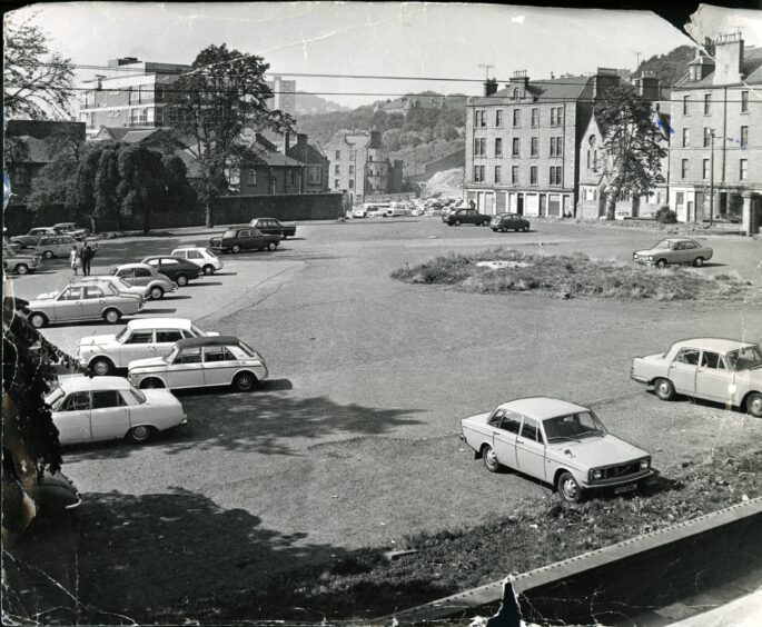 The old wall of the burial ground can be seen to the left of the image from 1971.