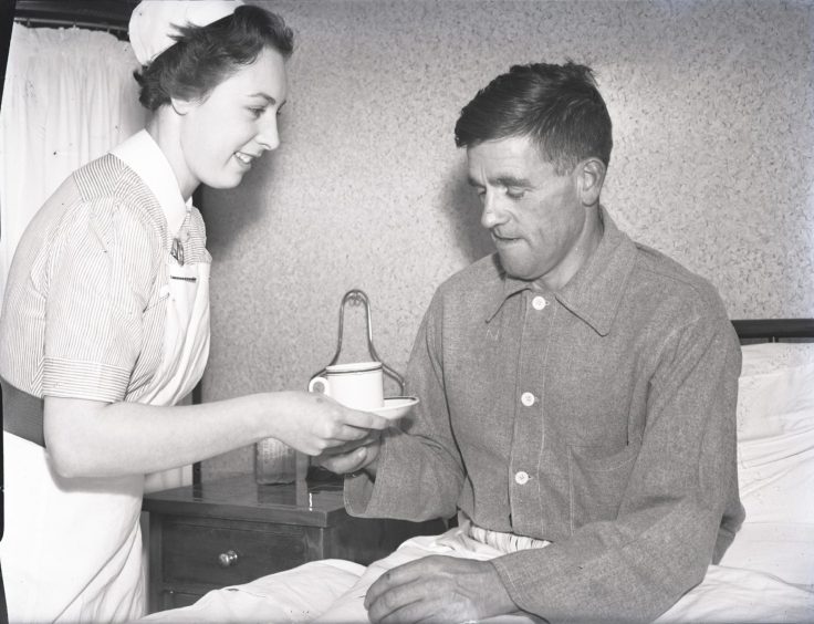 Survivor Archie Smith is given a cup of tea by a nurse in the hospital. Image: DC Thomson.