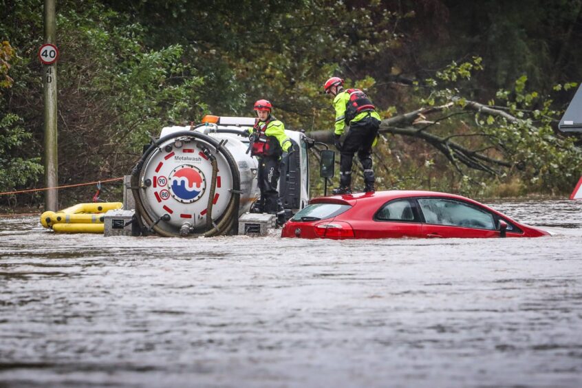 Rescue teams on Claverhouse Road where two vehicles were stranded. Image: Mhairi Edwards/DC Thomson.