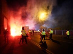 Police attempt to put out flares that have thrown towards them outside the stadium before the UEFA Europa Conference League Group E match at Villa Park, Birmingham. Picture date: Thursday November 30, 2023.