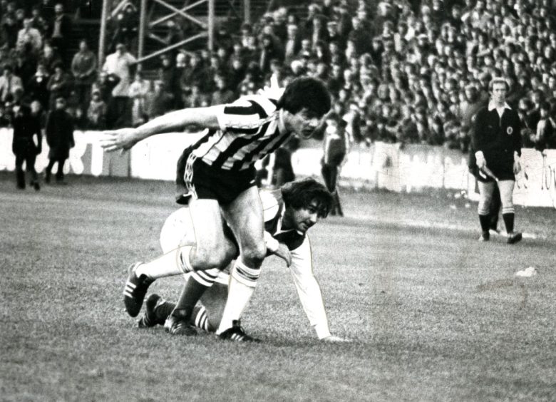 George Best in a tussle with Jackie Copland on his debut against St Mirren. Image: DC Thomson.