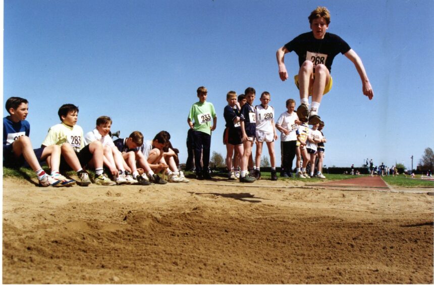 The long jump takes place as part of the Dundee BB Battalion sports day at Caird Park. Image: DC Thomson.