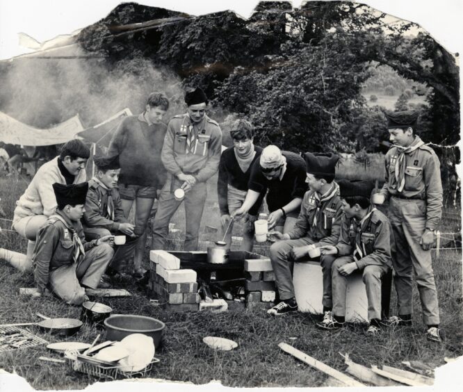 People around a campfire at the International Jamboree at Blair Castle in 1968. Image: DC Thomson.