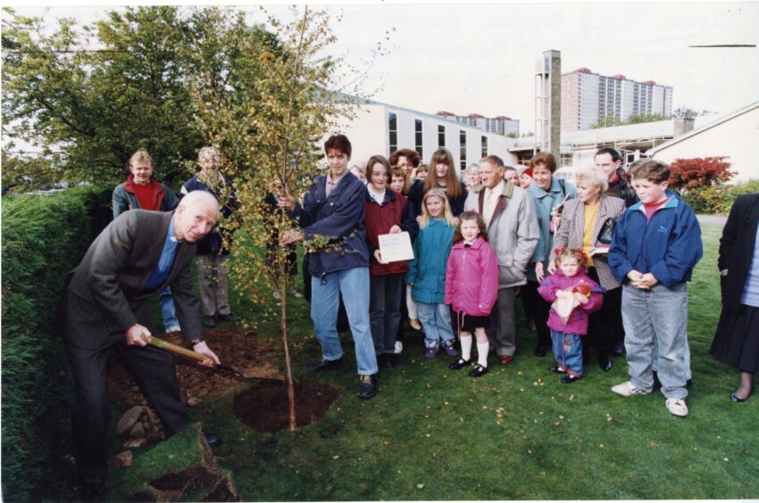 The hole is filled in at the tree planting ceremony. Image: DC Thomson.