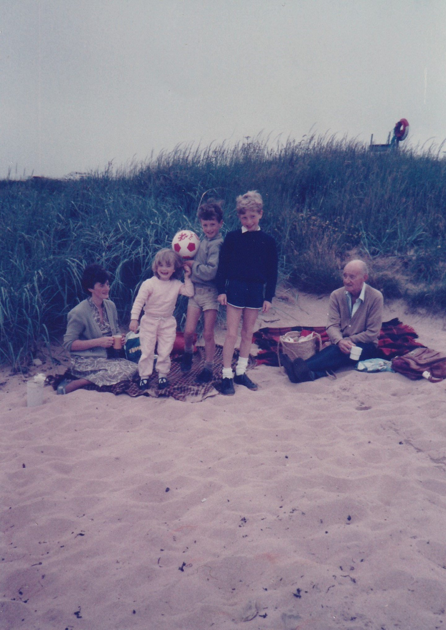 Neil Forsyth, typically holding a football, while with his family on the beach at Broughty Ferry. Image: Supplied.