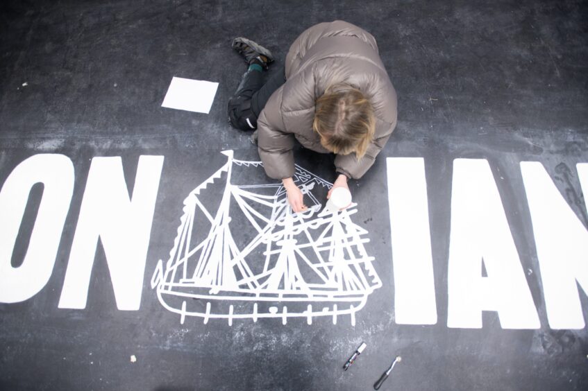 Artist Kate Benzies adds the finishing touches to her floor design. Image: Kim Cessford/DC Thomson.