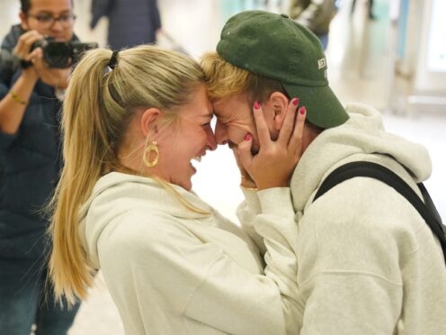 Series winner Sam Thompson is greeted by Zara McDermott at Heathrow Airport after taking part in I’m A Celebrity Get Me Out Of Here! in Australia (Jonathan Brady/PA)