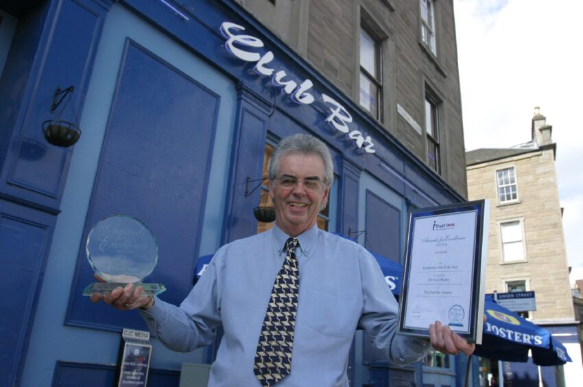 General manager Ron Duncan celebrating the Club Bar's 2006 success. Image: DC Thomson.