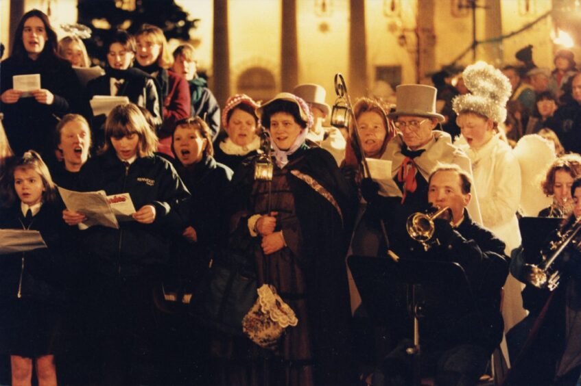 Children, carol singers and a band perform Christmas carols in the City Square. 