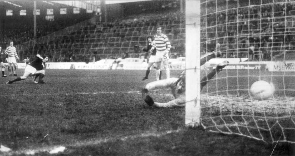 The ball crosses the line and Gordon Wallace turns away after scoring the only goal of the game. 