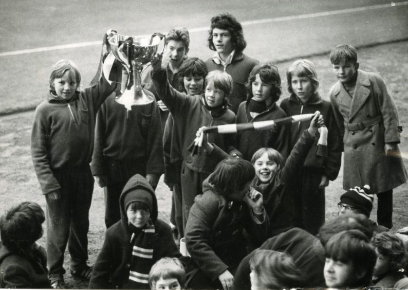 The Scottish League Cup being paraded round Dens Park by the ball boys. Image: DC Thomson.