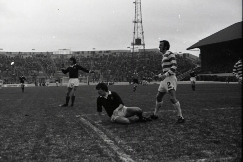 Dundee and Celtic players watch the ball inside the box at Hampden Park.