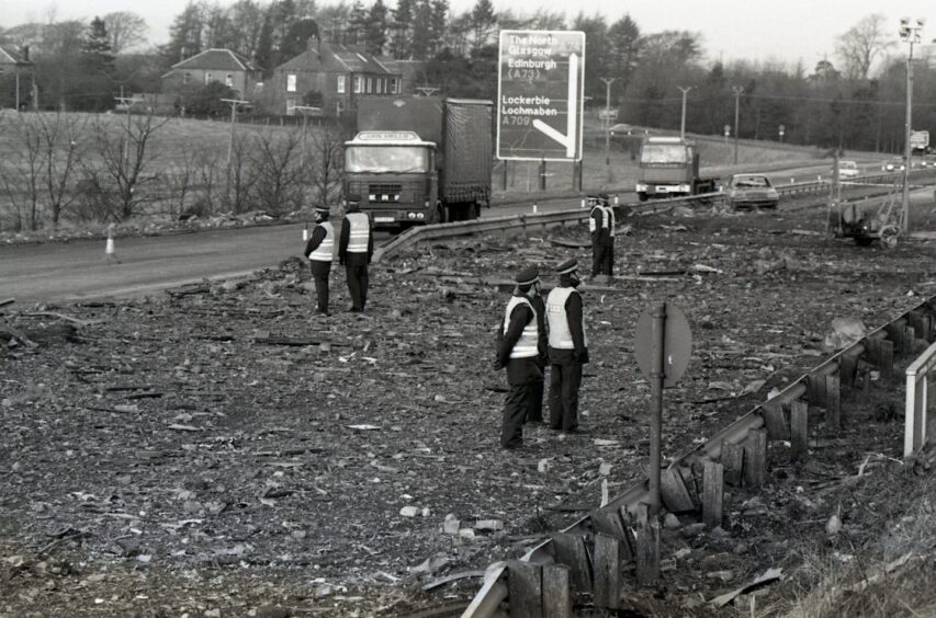 Police standing at the side of the motorway amid the debris. Image: DC Thomson.