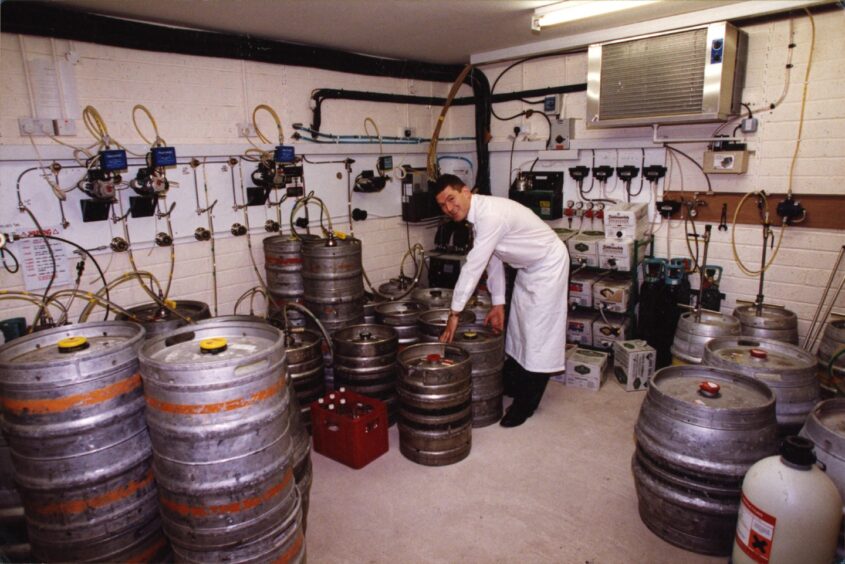 Gordon Paterson changes a keg at the Post Office Bar in Broughty Ferry. Image: DC Thomson.