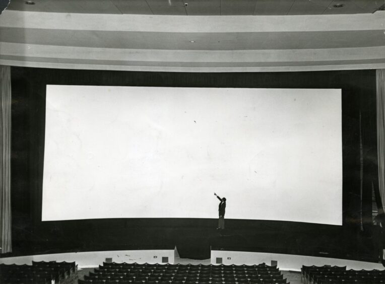 An individual standing in front of the mammoth screen in 1959. Image: DC Thomson.