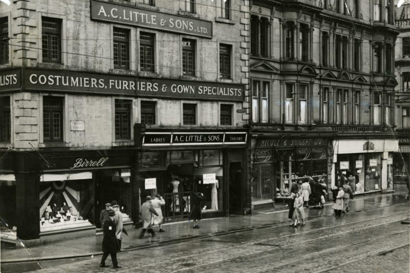 Photograph showing a general view of some of the shops and shoppers on High Street in 1949. Image: DC Thomson.