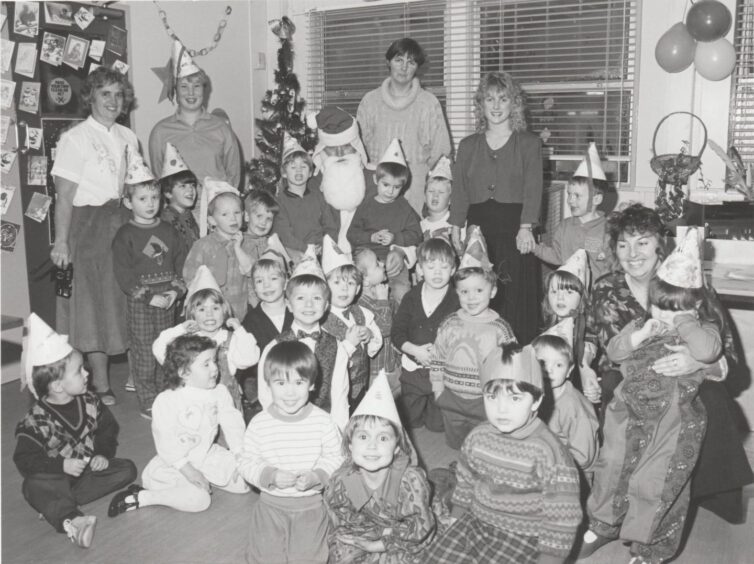 Kids, adults and Santa at Angus College creche in 1991. 