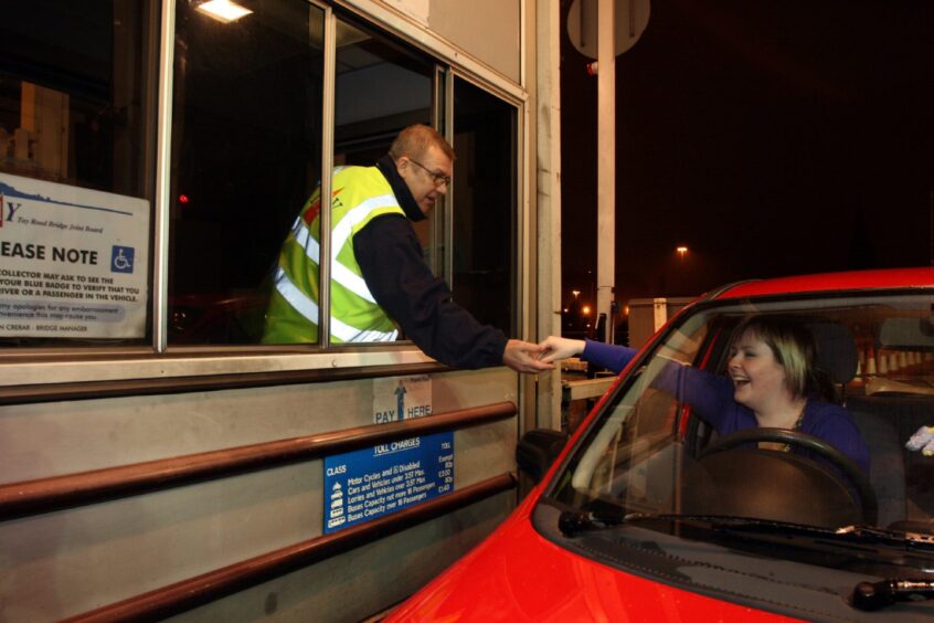 Toll collector Steve McLean takes the last toll from Ashley McGregor. 
