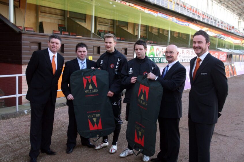 Jonathan Booth and Dougie Sherriff with some Dundee United players being handed suits for United before the 2008 League Cup final. 