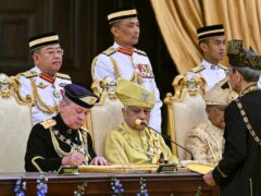 Sultan Ibrahim Sultan Iskandar, front left, signs documents during the oath taking ceremony as the Malaysia’s 17th king (Mohd Rasfan/AP)