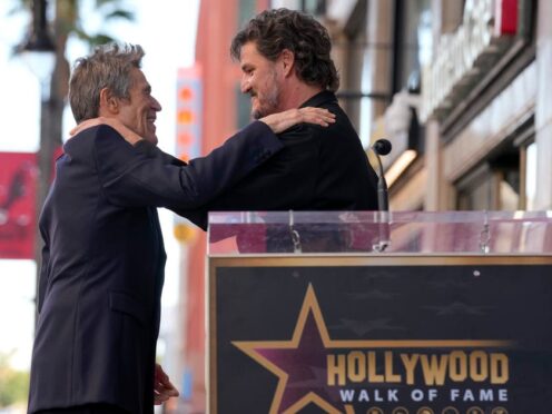 Pedro Pascal, right, embraces Willem Dafoe at a ceremony honoring Dafoe with a star on the Hollywood Walk of Fame (AP Photo/Chris Pizzello)