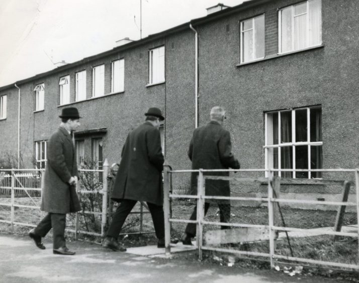 Police enter the house at 127 Macalpine Road. Image: DC Thomson.
