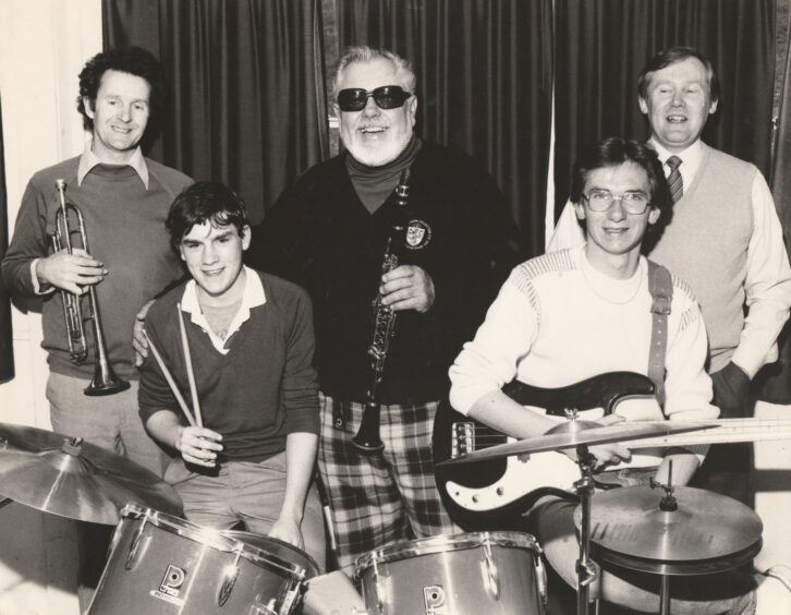 Pupils and staff beside a drum kit for the musical masterclass at Arbroath High Schoolin 1984. 