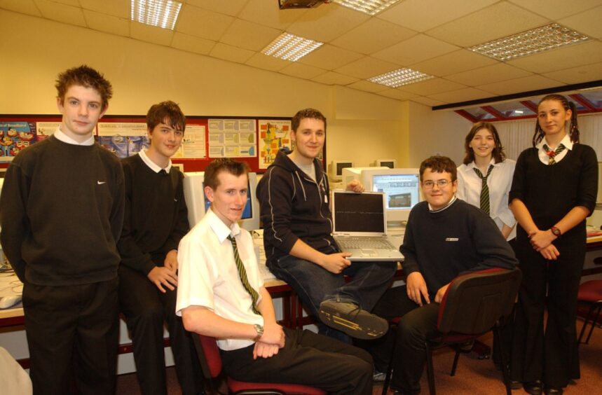 Andrew Grier with the pupils at the website club, seated around a PC