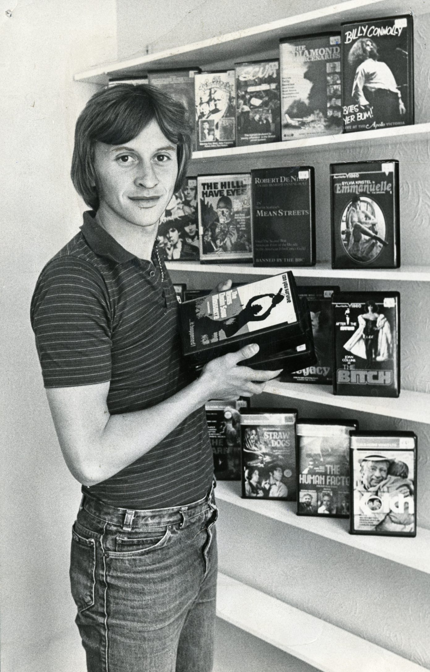 Paul Sturrock putting stock on the shelves of his Video Library in 1981. 