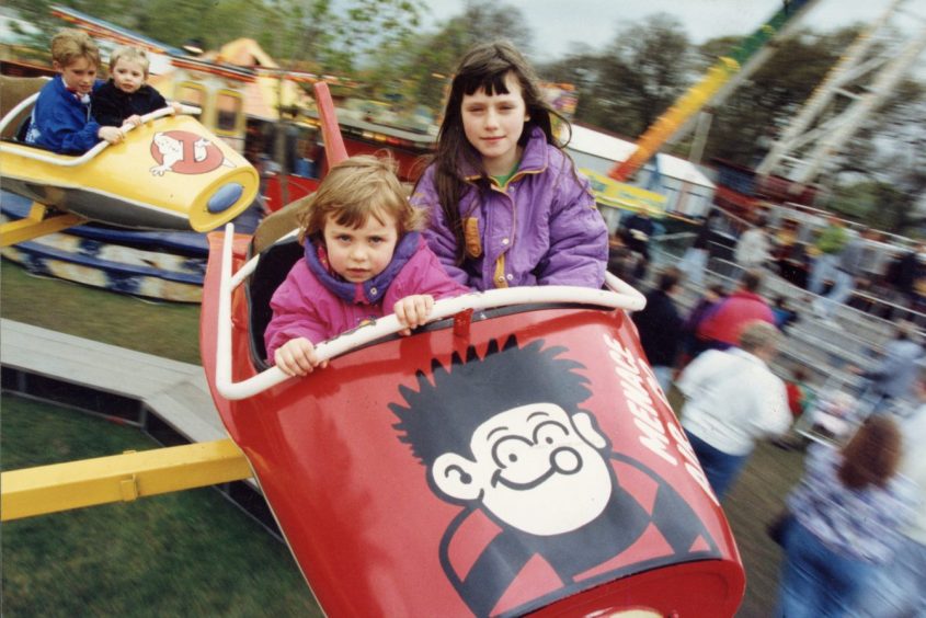 Two young girls have fun on the Mini Jet ride at Caird Park in 1992. 