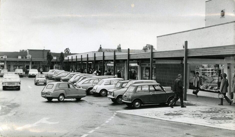Shoppers and parked cars outside the parade of Barnhill shops.