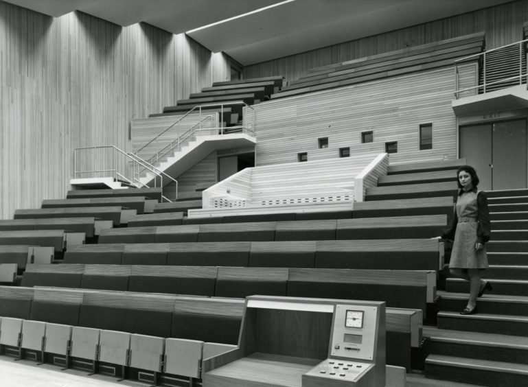 A female stands in the empty lecture theatre at Ninewells Hospital in Dundee