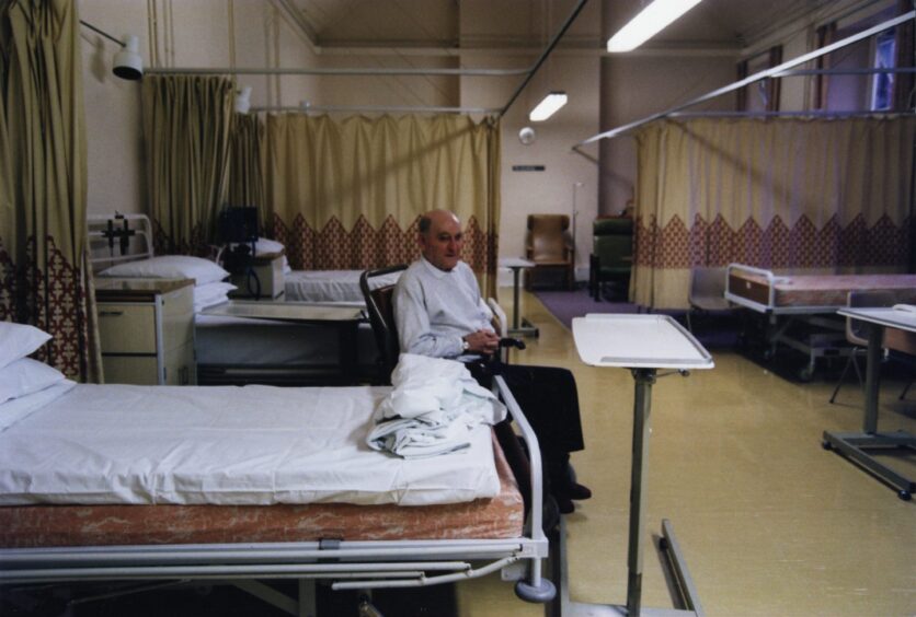 A final patient sitting in a wheelchair in the empty ward in November 1998.