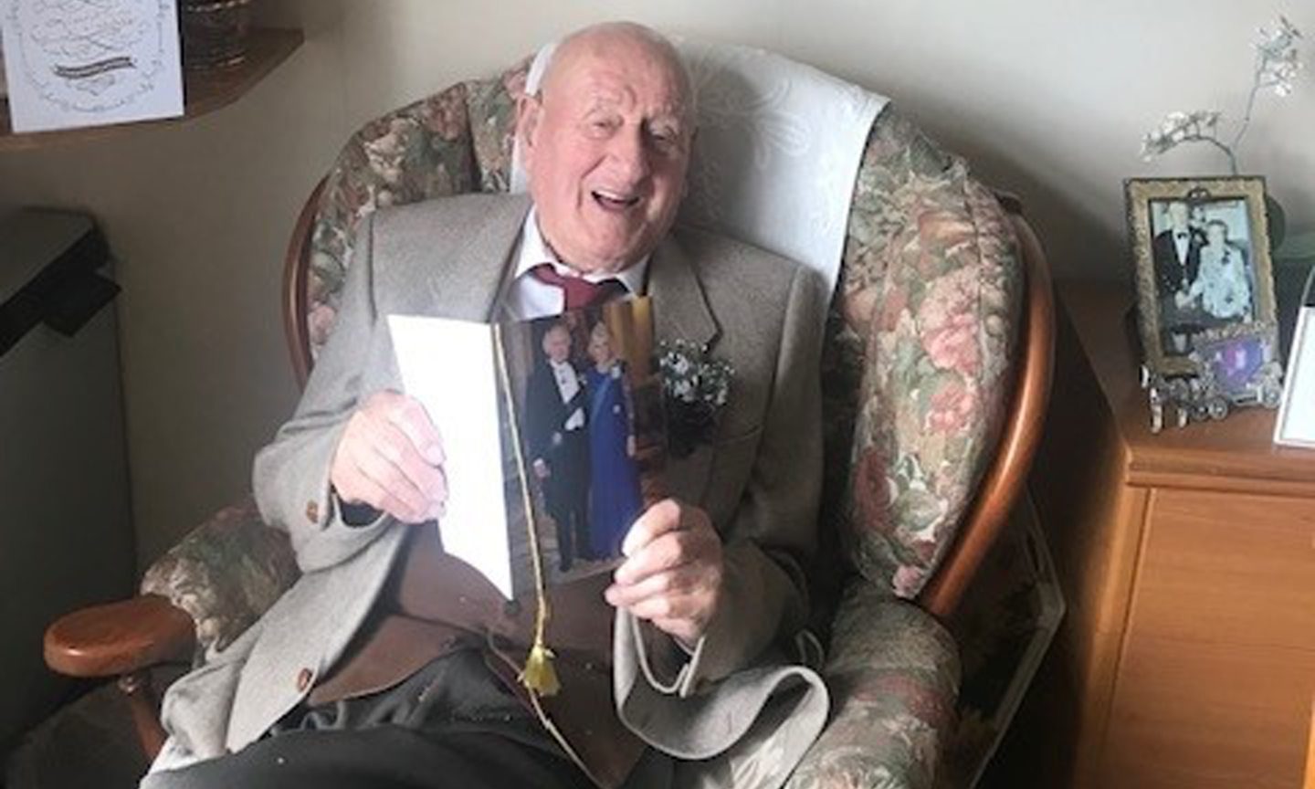 Sandy Mutch celebrating his 100th birthday, with a card from the king