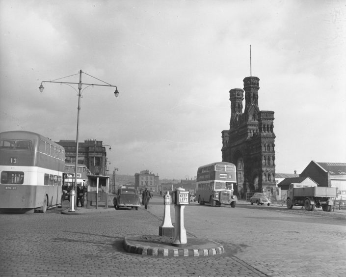 Dock Street with the Royal Arch on the right and Shore Terrace bus stances on the left.