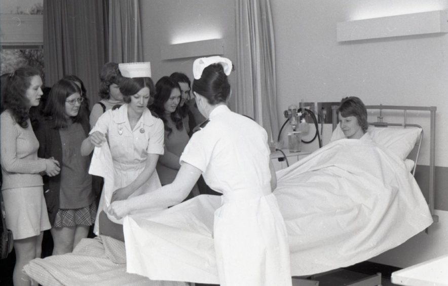 Students watching the nurses with a patient at Ninewells Hospital