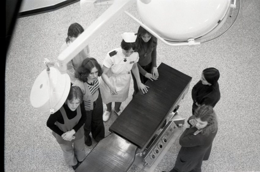 Another view, from an elevated position, from inside the hospital when it opened, showing people gathered around a work station