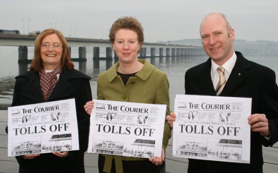 Tricia Marwick, Shona Robison and Joe FitzPatrick from the SNP hold up copies of The Courier newspaper while standing in front of the Tay Road Bridge